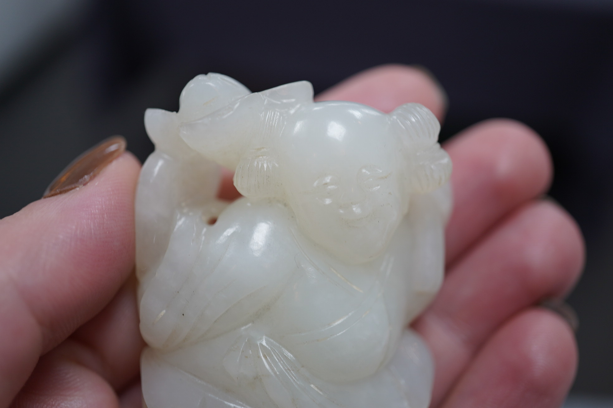 A Chinese white jade figure of a kneeling boy holding lingzhi fungus, 19th century